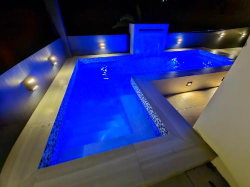 a swimming pool with blue lights on top of it at Staycation At Sandari Batulao Overlooking Spot in Tagaytay