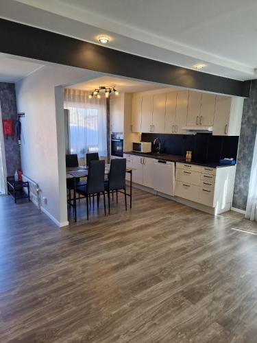 a kitchen and dining room with a table and chairs at Modernt gästhus på 90 m2 för upp till 8 personer in Västervik