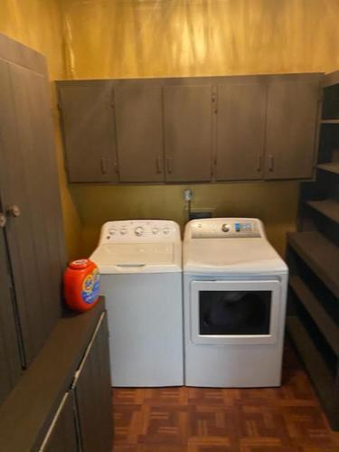 a small kitchen with a stove and a dishwasher at Evergreen Estates 3-Bedroom Private in Fayetteville