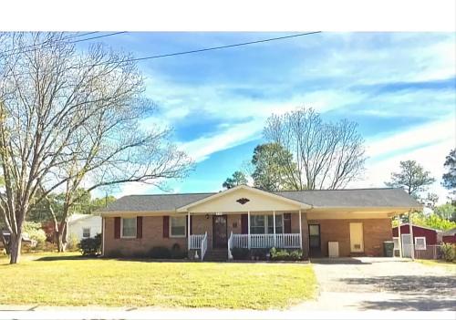 a home in a subdivision with a yard at Evergreen Estates 3-Bedroom Private in Fayetteville