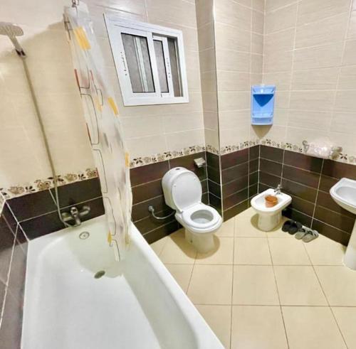 a bathroom with a toilet and a sink at Appartement in Nador in Nador