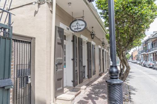 a clock on the side of a building on a street at Inn on Ursulines, a French Quarter Guest Houses Property in New Orleans