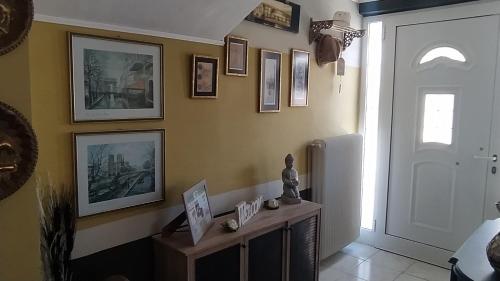 a hallway with paintings and pictures on the wall at Enjoy Hospitallity at Fully Equipped apartment with Free parking- Near the Ancient Olympia in Pýrgos