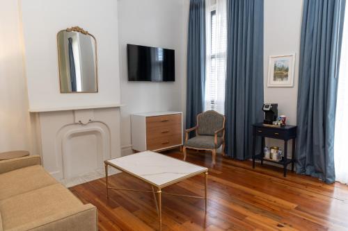 a living room with a couch and a tv at Inn on St. Ann, a French Quarter Guest Houses Property in New Orleans