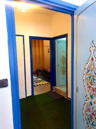 an open door to a room with green carpet at Casa Plasa Grande in Chefchaouene