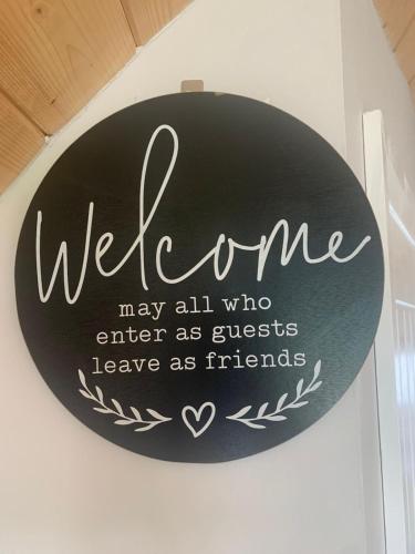 a sign that says welcome may all who enter as guests leave as friends at Seaview Glamping Cabin Inishowen in Creehennan