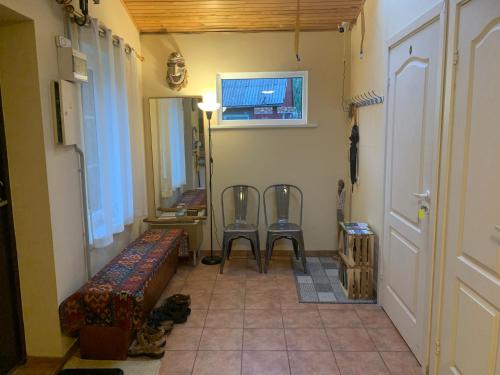 a hallway with two chairs and a table in a room at Artless #2 in Plateliai