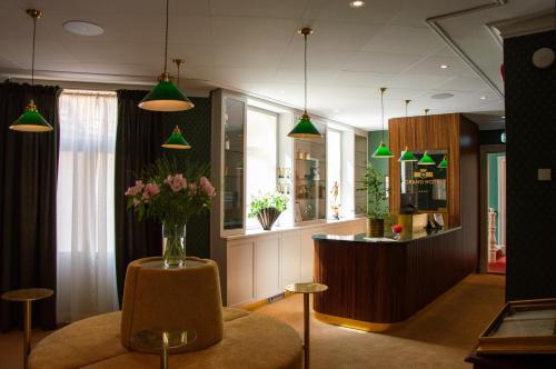 a lobby with a vase of flowers on a table at Grand Hotel Marstrand in Marstrand