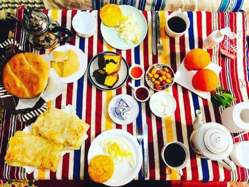 a table with plates of breakfast food on it at Casa Plasa Grande in Chefchaouene