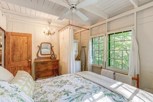 a bedroom with a bed and a mirror and a window at about 1 Mi to Dtwn Grand Haven Lake Michigan Cabin in Grand Haven