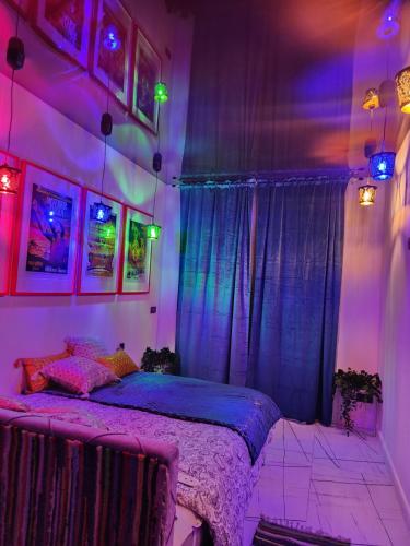 a bedroom with a bed with purple and pink lighting at WARSZAWA CENTRAL HOUSE - Studios in Warsaw with Private Jacuzzi, full access to Sauna, Gym and Billards - Studia z prywatnym Jacuzzi oraz dostępem do sauny, siłowni i bilarda in Warsaw