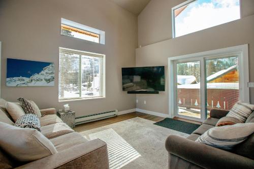 a living room with two couches and a flat screen tv at Private Home Perfectly Located at Brighton Ski Resort! in Brighton