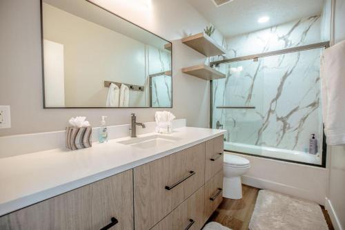 a bathroom with a sink and a toilet and a mirror at Private Home Perfectly Located at Brighton Ski Resort! in Brighton
