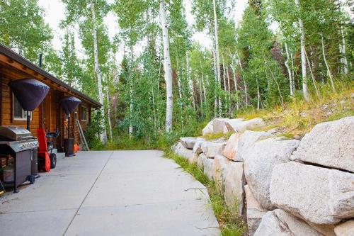 a path next to a stone wall next to a house at Uinta Lodge in Brighton