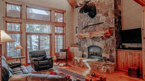 a living room with a large stone fireplace at Rivamonte in Brighton
