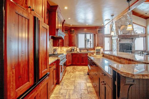 a large kitchen with wooden cabinets and a large island at Castle Butenham in Brighton