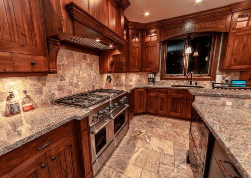 a kitchen with wooden cabinets and a stove top oven at Castle Butenham in Brighton