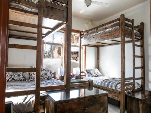 a room with two bunk beds and a desk at Wanderlust Suite in Brighton