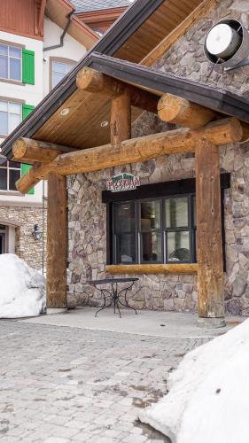 a stone building with a bench in front of it at Basecamp in Solitude