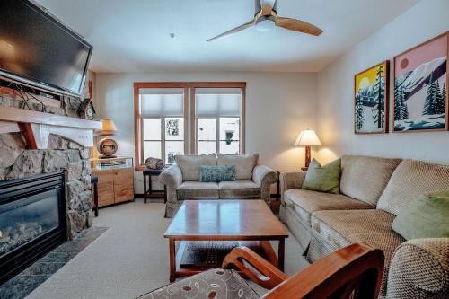 a living room with a couch and a fireplace at Apex View in Solitude