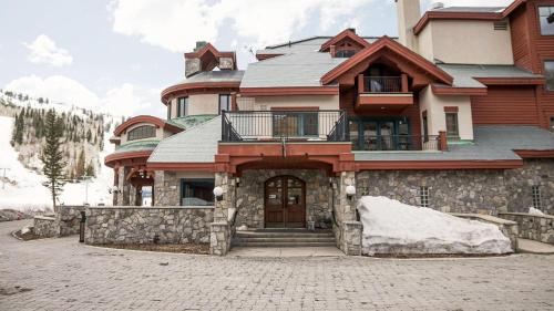 a large house with a stone wall at Apex View in Solitude