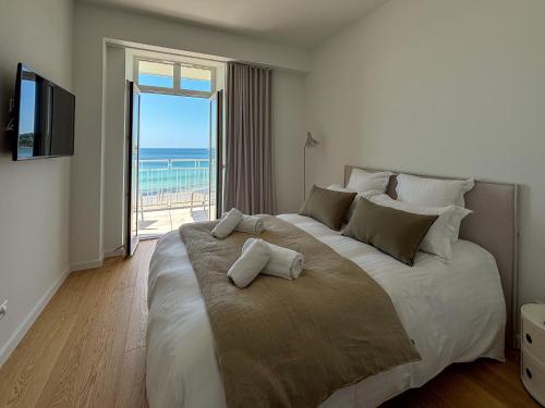 une chambre avec un grand lit avec vue sur l'océan dans l'établissement Bihit T2, trebeurden, à Trébeurden