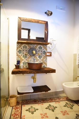 a bathroom with a sink and a mirror on a wall at Casa Nonna Generosa in Agerola