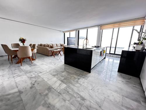 a kitchen and living room with a couch and a table at Playablanca Luxury Beach Apartment First Floor in Tanger in Tangier