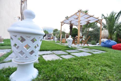a white vase sitting on the grass in a yard at Casa Nonna Generosa in Agerola