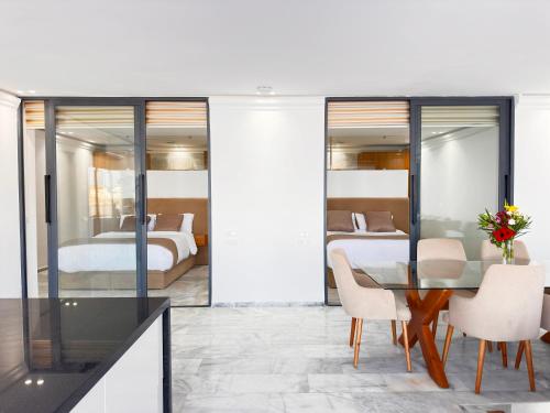 a dining room with a table and two beds at Playablanca Luxury Beach Apartment First Floor in Tanger in Tangier