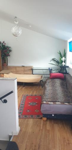 a living room with a bed and a rug at Cozy central APARTMENT Leopoldstrasse -3,5 rooms with sauna and garden in Munich