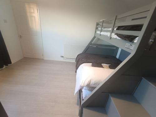 a bedroom with a bunk bed and a staircase at Alton Towers & Foxtail Barns & Oak Barns & Peak District in Wetleyrocks
