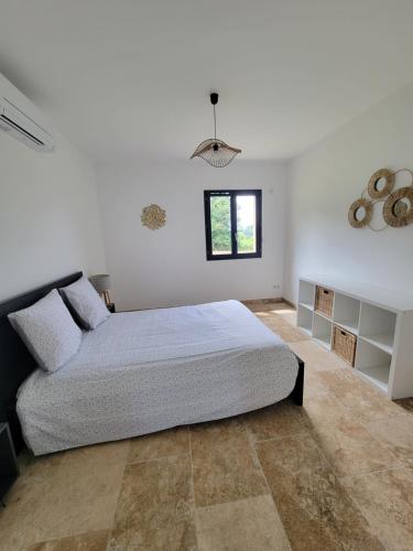 une chambre avec un grand lit et une fenêtre dans l'établissement Belle maison neuve, au Buisson de Cadouin