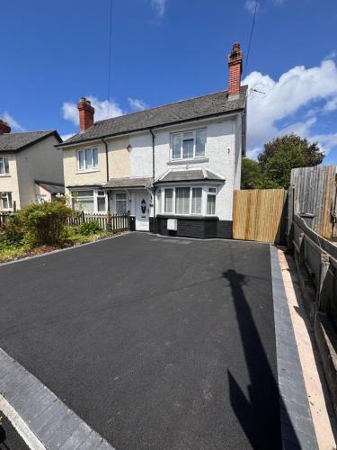 a long shadow of a house with a driveway at Sophisticated Home with Beautiful & Large Garden in Cardiff