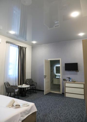 a hotel room with a bed and a television at A E K A Hotel in Yerevan