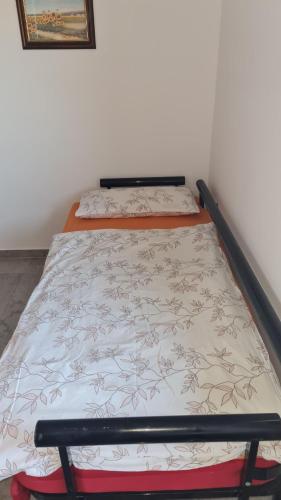 a bed in a room with a bed frame at Hiša nad vinogradom in Ptuj