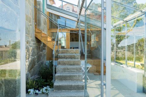 a house with a staircase in front of a building at A Casa dos Caseiros ツ by Rias Baixas Rentals in Gondomar