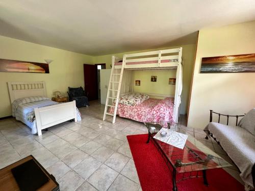 a living room with two bunk beds and a couch at B&b La Baronata - Pescosansonesco (Pe) in Pescosansonesco