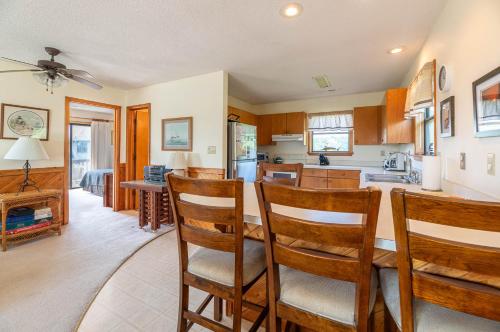 a kitchen and living room with a table and chairs at Persimmon in Duck