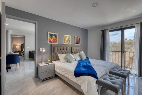a bedroom with a bed with a blue blanket on it at Cabo Cove 408 in Cabo San Lucas