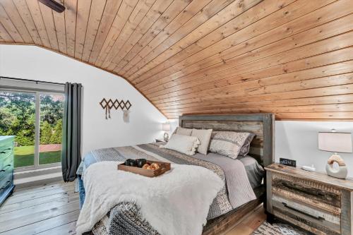 a bedroom with a bed with a dog laying on it at Rustic Barn Retreat in Knoxville