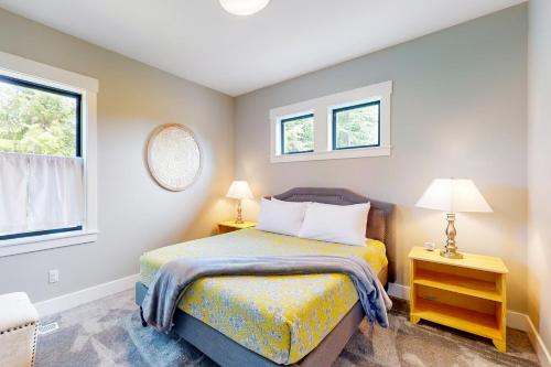 a small bedroom with a bed and two windows at Pacific Paradise in Pacific Beach