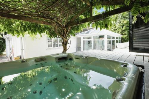 a jacuzzi tub in the backyard of a house at 4 Bedroom House By Guest Nest Management Vacation Rental Brighton With Hot Tub & Pet Friendly in Brighton & Hove