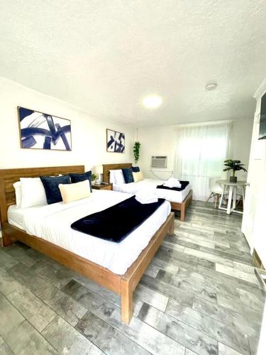 a large bedroom with two beds and a table at 2q Beds Studio With Shared Pool 05 in Clearwater