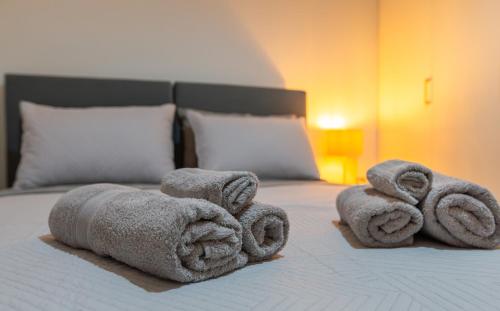 a pile of towels sitting on top of a bed at My Nafpaktos Resort in Nafpaktos