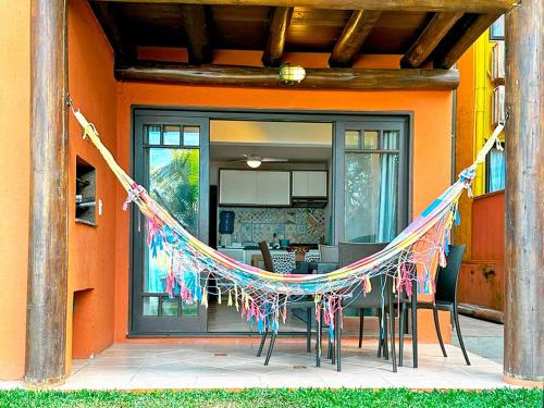 a house with a string of flags on a patio at Pousada Pedra da Gaivota in Bombinhas