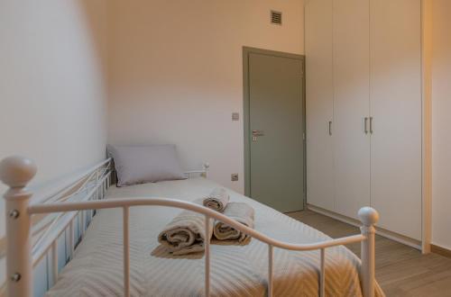 a bedroom with a bed with towels on it at My Nafpaktos Resort in Nafpaktos