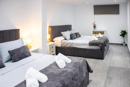 a bedroom with two beds with white pillows at Gaviotas Beach Golf in Almerimar