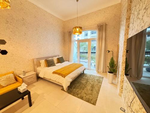 a bedroom with a bed and a large window at Serene Studio In Yas Island - Near Zayed Int Airport in Abu Dhabi