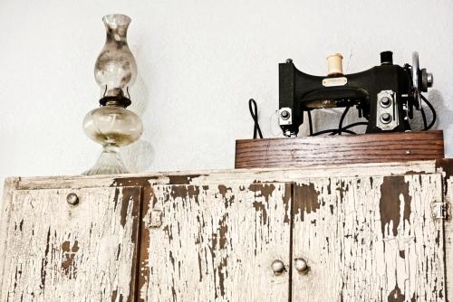 an old camera and a lamp on top of a cabinet at Budget Studio Near Paseo Art & Uptown Okc #03b in Oklahoma City